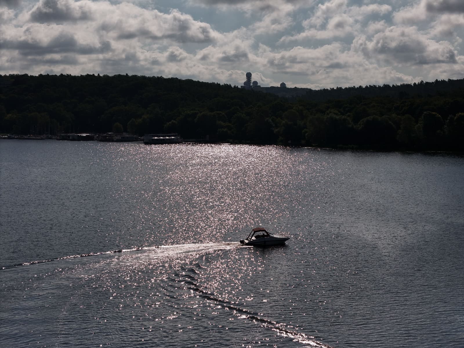 Motorboat cruising across the lake in the afternoon sun