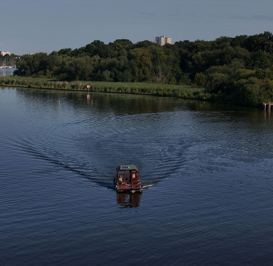 Boat cruising on the Havel with trees in the background